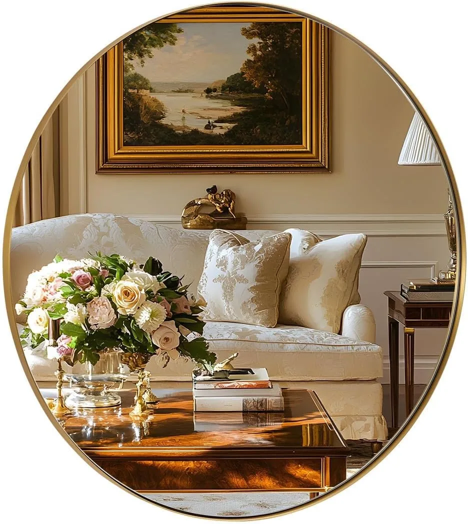 A thin-framed round brushed gold mirror with a 1-inch deep-set design